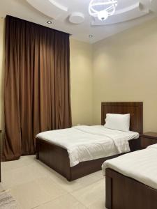 a bedroom with two beds and a window at سويت غرفتين وصالة مميز in Jeddah