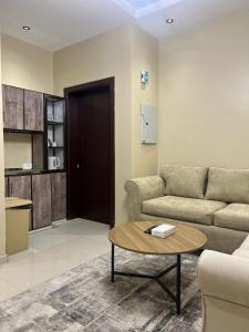 a living room with a couch and a table at سويت غرفتين وصالة مميز in Jeddah