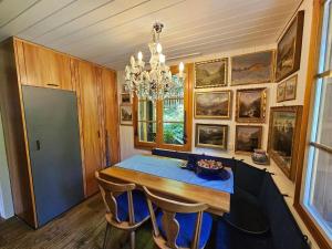 a dining room with a blue table and chairs at Chalet Tannegüetli in Grindelwald