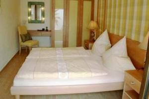 a bedroom with a large white bed and a chair at Casa Alhambra 4 6 P in Guía de Isora +29 photos