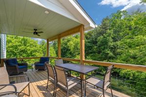 a patio with a table and chairs on a deck at Riverfront Fishing, Firepit, Only 4 Miles to the Speedway in Bluff City