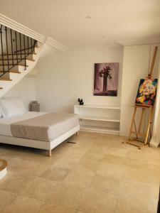 a bedroom with a bed and a painting on the wall at La Villa in Sainte-Maxime +12 photos