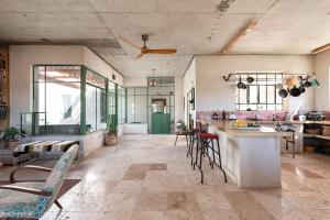 a kitchen with a counter and chairs in a room at הבית האנדלוסי in H̱aẕeva