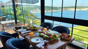 a table with food and a view of the ocean at Marina Boutique Hotel Istanbul Airport in Karaburun