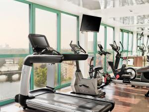 a gym with treadmills and elliptical machines at ABION Spreebogen Waterside Hotel Berlin in Berlin
