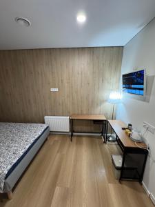 a small room with a bed and a desk at 15 New Airport Apartment in Vilnius