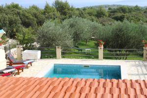 - une piscine entourée d'arbres à côté d'une cour dans l'établissement Geräumige Ferienvilla Mit Pool Und Meerblick, à Grohote
