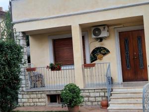 a house with a balcony and a door with a fan at CasaMiria in Seravezza +2 photos