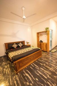 a bedroom with a bed and a ceiling fan at Taprobana Island Bliss in Dickwella