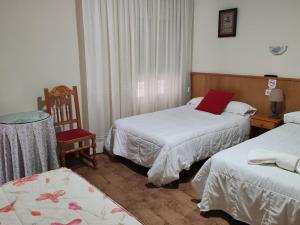 Postel nebo postele na pokoji v ubytování Hostal Ponte Dos Santos