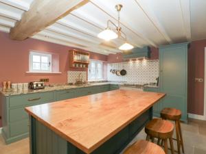 a kitchen with a wooden counter top in a room at Velindra Farm Cottage in Hereford