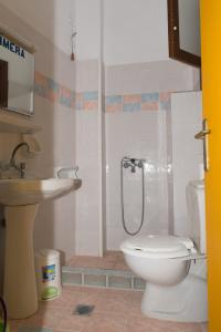 a bathroom with a toilet and a sink at Villa Maria in Kokkari