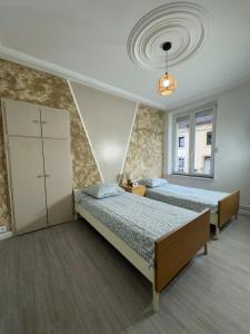 Ένα ή περισσότερα κρεβάτια σε δωμάτιο στο Appartement proche Amnéville, 2 chambres, 5 couchages, cuisine, salon, terrasse et parking