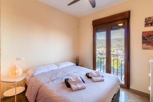 a bedroom with a large bed with a large window at RentitSpain - Almuñecar - Vistas Increíbles al mar en Apartamentos Lambda in Almuñécar +49 photos