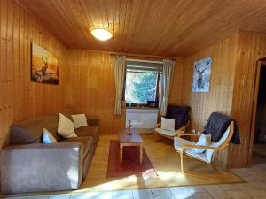 a living room with a couch and chairs and a table at Appartement Murtalblick In Pöls in Pöls