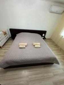 two towels on a bed in a bedroom at Veronika Apartments in Berehove