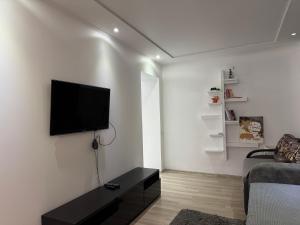 a living room with a flat screen tv on a wall at Veronika Apartments in Berehove