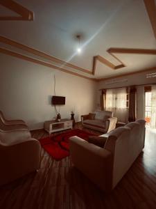 a large living room with couches and a tv at Jseason Faith-based retreat resort in Kagolomolo