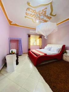 a bedroom with a large bed and a ceiling at Jseason Faith-based retreat resort in Kagolomolo +7 photos