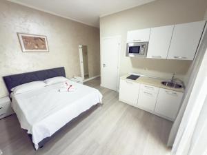a bedroom with a white bed and a microwave at MyRoom in Ariano Irpino