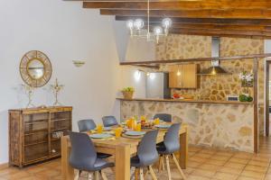 a kitchen and dining room with a wooden table and chairs at Villa Marilen in Alcudia