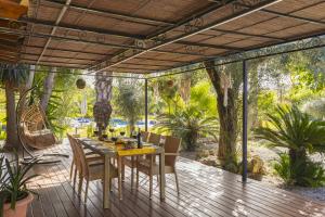 a wooden deck with a table and chairs on it at Villa Marilen in Alcudia