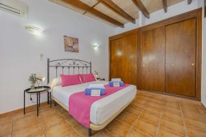 a bedroom with a large bed and a wooden closet at Villa Marilen in Alcudia +42 photos