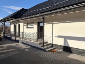 a white building with a balcony with a fence at Râului 43 in Ocna-Mureşului