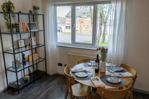 a dining room with a table and a window at Lakeside Nook Garden Parking 4 people in Birmingham