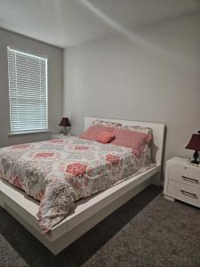 米德兰Spacious Home Perfect for Families& Business Trips的一间卧室，床上有红色枕头