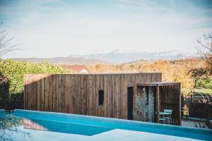 a small house with a swimming pool next to it at Le Studio du Hameau in Sales