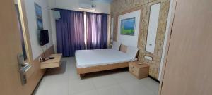 Ένα ή περισσότερα κρεβάτια σε δωμάτιο στο Hotel O Phoenix Ac Rooms