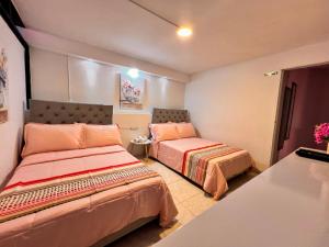 a bedroom with two beds in a room at Casa La Morada in Medellín
