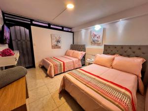 a bedroom with two beds in a room at Casa La Morada in Medellín