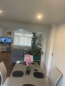 a living room with a table with flowers on it at Cassandra Homes in Nevendon +18 photos