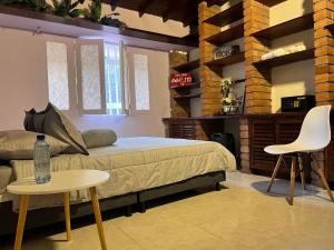 a bedroom with a bed and a table and chairs at Casa La Morada in Medellín +19 photos