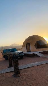 a truck parked next to a tent in the desert at Wadi Rum Abu Khaled in Wadi Rum