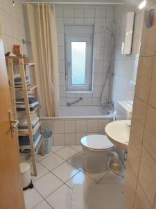 a bathroom with a toilet and a tub and a sink at Little Castle in Bad Kreuznach
