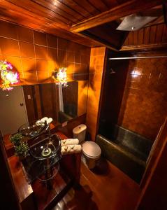 a bathroom with a sink and a toilet and a tub at Casa La Morada in Medellín