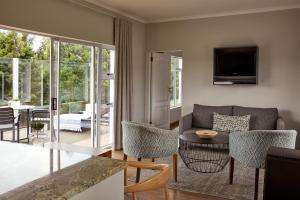 a living room with a couch and a table at Brahman Hills - Gardens, Spa, Hotel & Villas - 5star in Nottingham Road