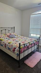 una camera da letto con un letto con un piumone e una finestra di Prime Location Home Family & Business Ready a Midland Altre 11 foto