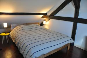 um quarto com uma cama num quarto com janelas em L'écluse de Saverne em Saverne