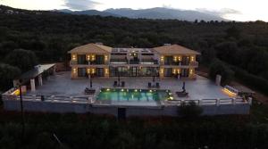an aerial view of a large house with a swimming pool at Queen Bee Luxury Villa- Sparto in Spartos