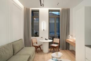 a living room with a couch and a table at Anfides Boutique Hotel in Patra