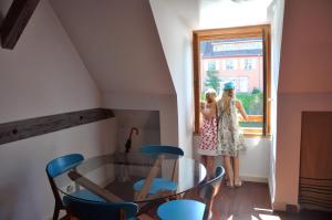 two girls standing in a room looking out a window at L'écluse de Saverne in Saverne