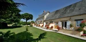 a house with a lawn in front of it at Gîte Charly in Salignac Eyvigues