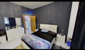a bedroom with a large bed and a dresser at private room in Seveso