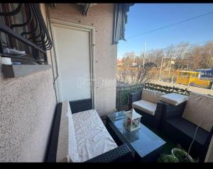 a balcony with a couch and a glass table at private room in Seveso