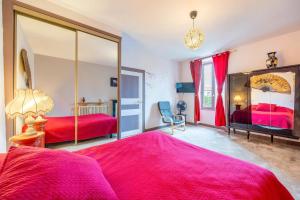 a bedroom with two beds and a large mirror at Chambre Nuit d'Asie in Montournais