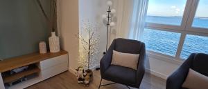 a living room with a chair and a window at Playa Petís in Bueu